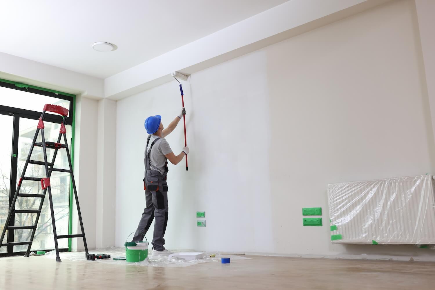 Bates Brothers painter prepping siding on Pittsford area home