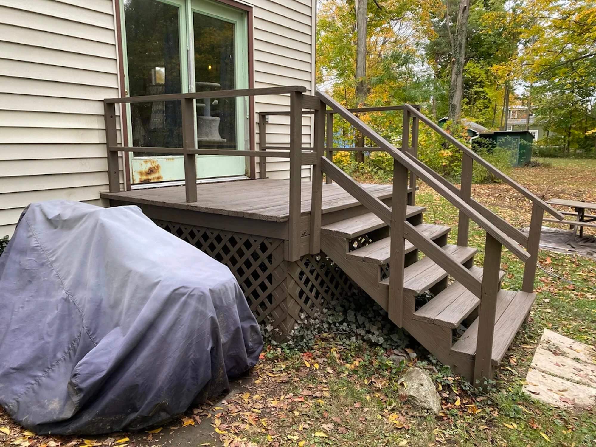 professionally stained wood deck and stairs outside rochester home