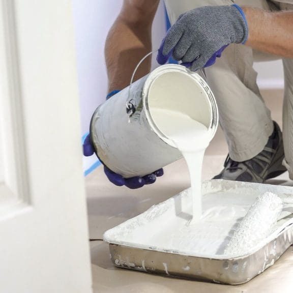 interior painting crew working with drop cloths in Pittsford NY home